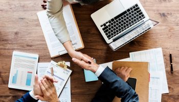 Business people shaking hands together