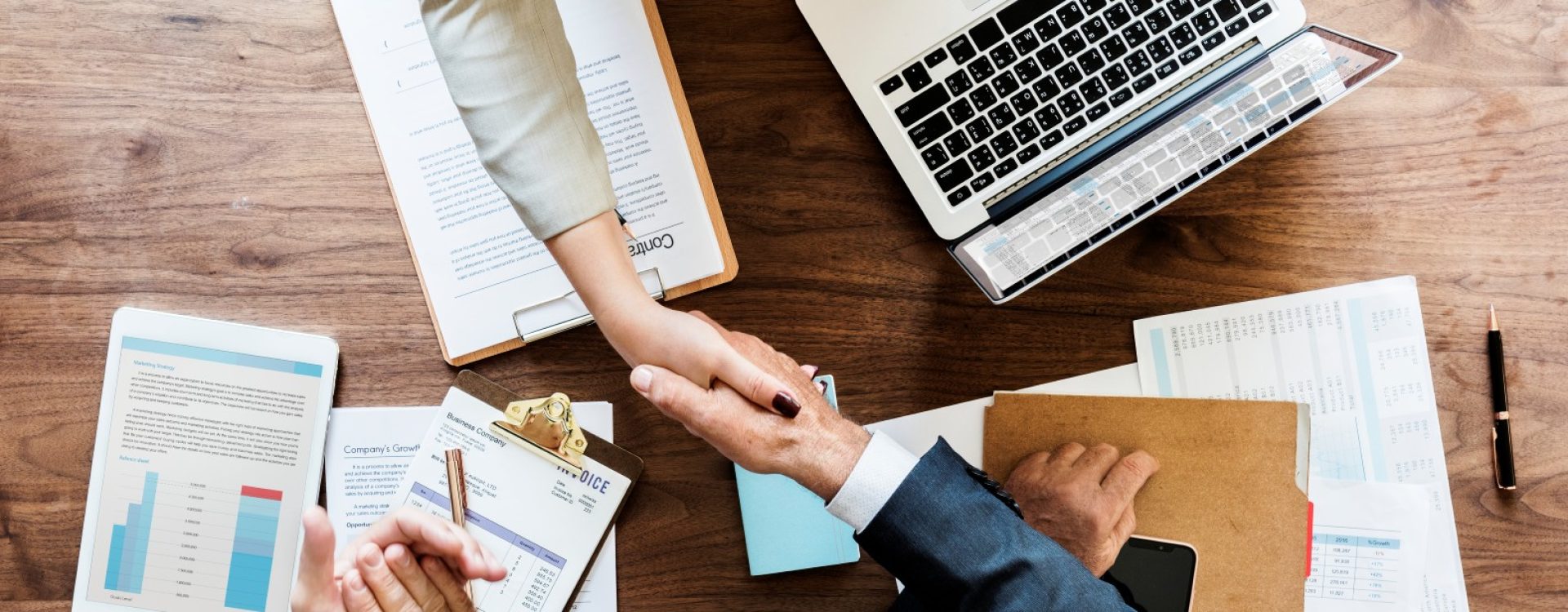 Business people shaking hands together