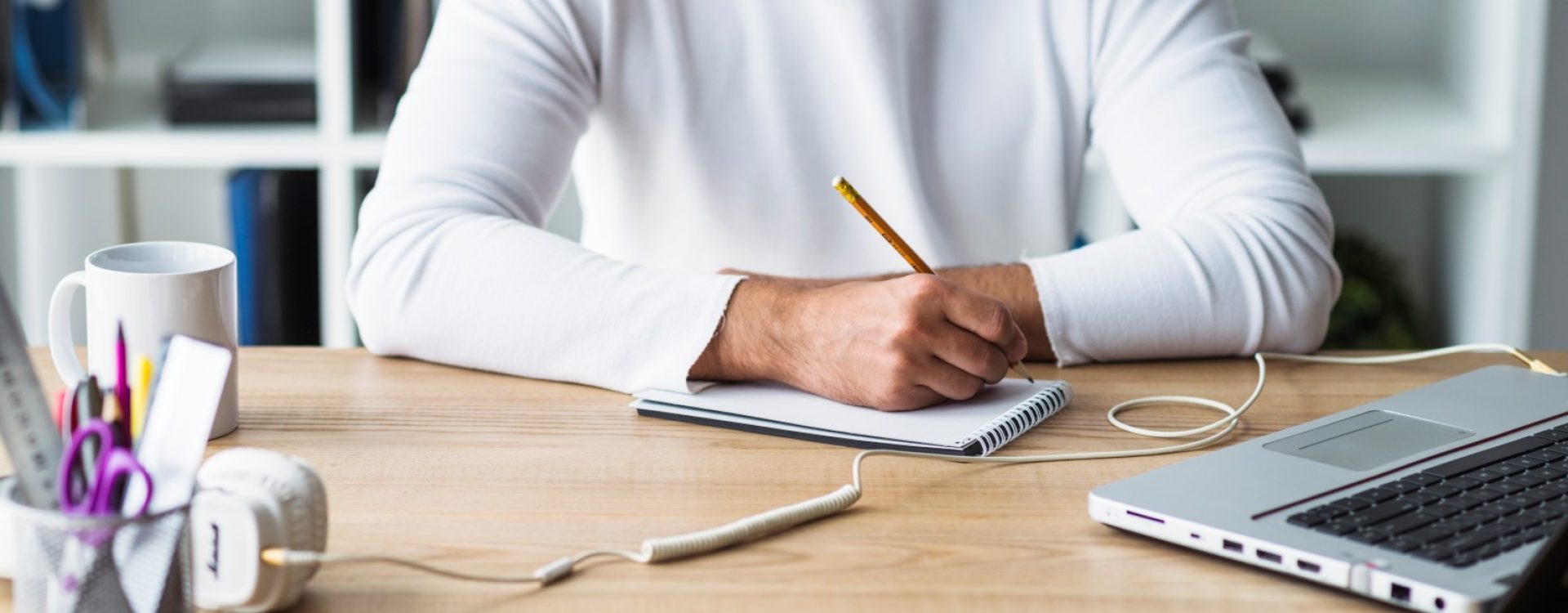 businessman-writing-notepad-wooden-desk (Large)