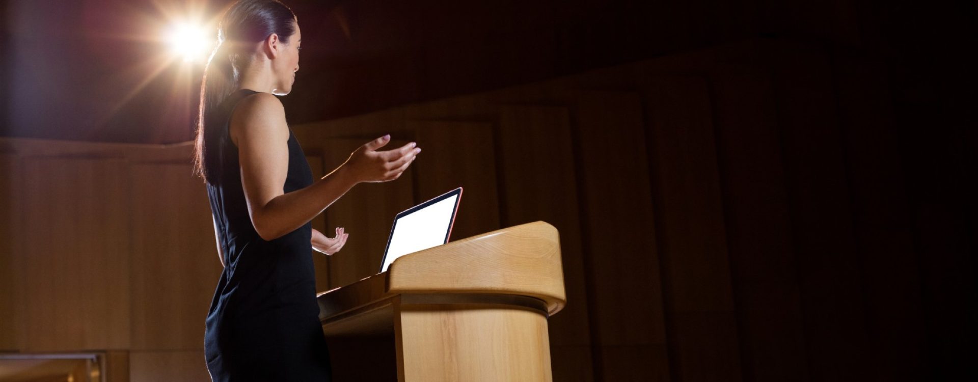Female business executive giving a speech at conference center