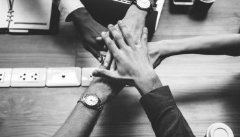 Team of business people stacking hands