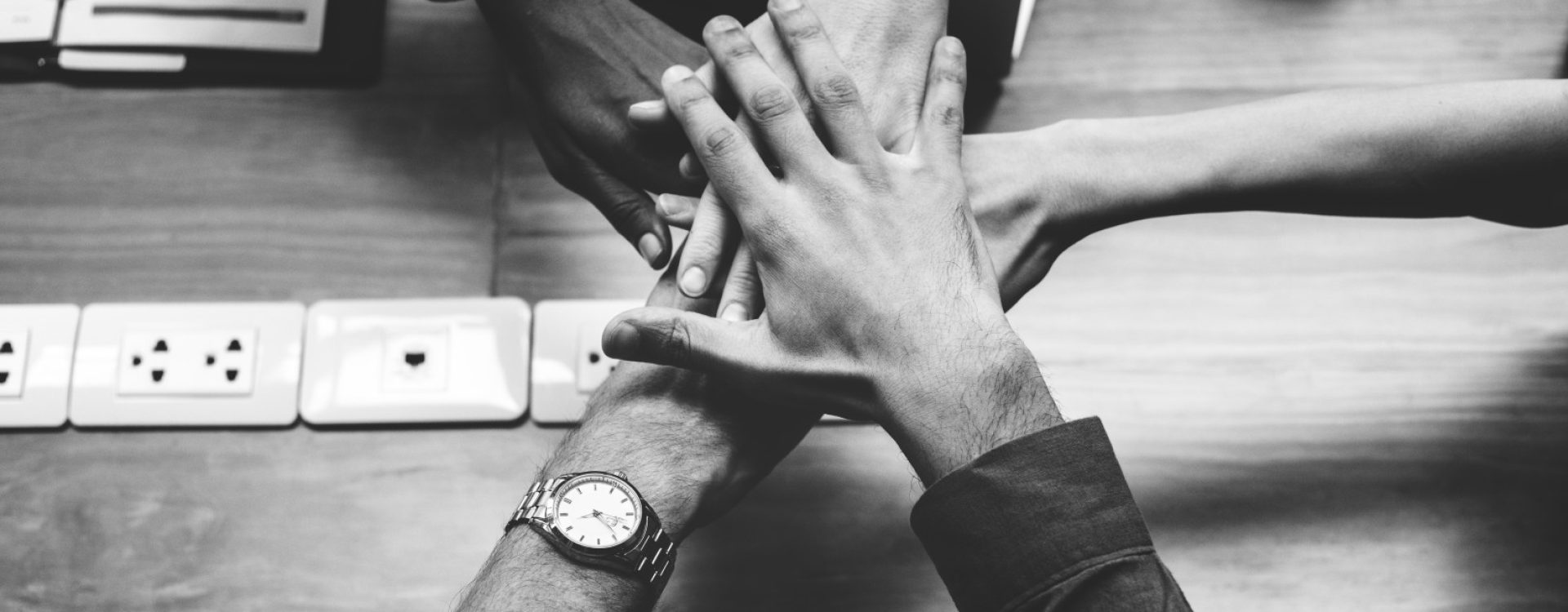 Team of business people stacking hands